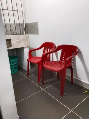 two red chairs sitting on a tiled floor at Apartamento Capri 2 in Puerto Triunfo
