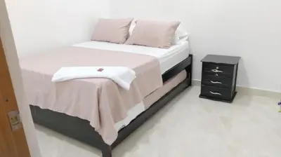 a bedroom with a bed and a night stand at Apartamento Capri 2 in Puerto Triunfo