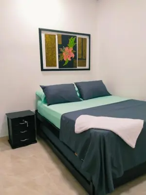 a bedroom with a bed with a blue comforter at Apartamento Capri 2 in Puerto Triunfo