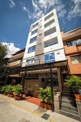 a building with potted plants in front of it at Hotel Doxa in Medellín