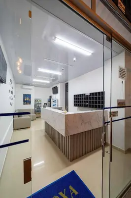 a lobby with a reception counter in a building at Hotel Doxa in Medellín