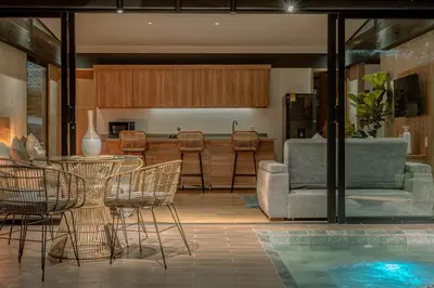 a living room with a table and chairs and a pool at Soy Local Reserva Sajonia in Rionegro