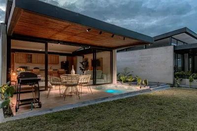 a house with a deck with a grill and a pool at Soy Local Reserva Sajonia in Rionegro