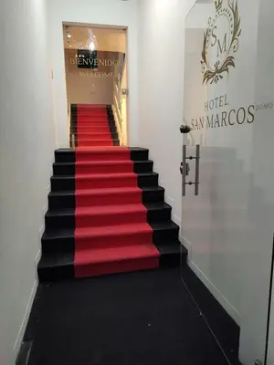 a red and black staircase with a red carpet at Hotel San Marcos in Manizales