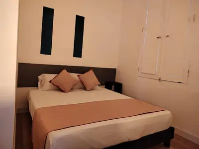a bedroom with a bed with two pillows on it at Hotel San Marcos in Manizales