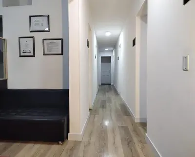 a hallway with a black couch in a room at Hotel San Marcos in Manizales