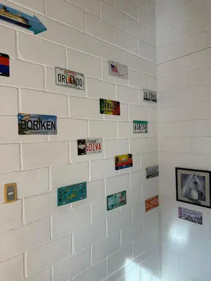 a white brick wall with signs on it at Cabaña ciudadela del sol in San Jerónimo