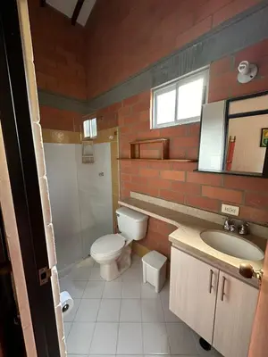 a bathroom with a toilet and a sink at Cabaña ciudadela del sol in San Jerónimo