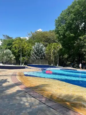 a swimming pool with a red float in the middle at Cabaña ciudadela del sol in San Jerónimo