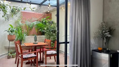 a table and chairs on a patio with plants at Loft con Patio privado in Medellín
