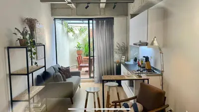 a living room with a couch and a table at Loft con Patio privado in Medellín