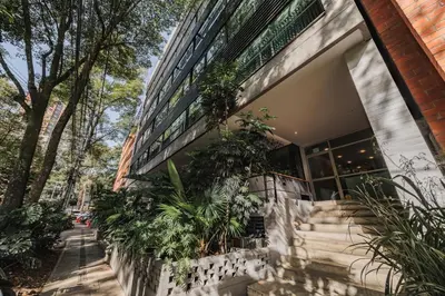 a building with plants on the side of it at Spot Building - Apartments in Medellín
