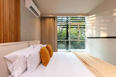 a bedroom with a large white bed with orange pillows at Spot Building - Apartments in Medellín