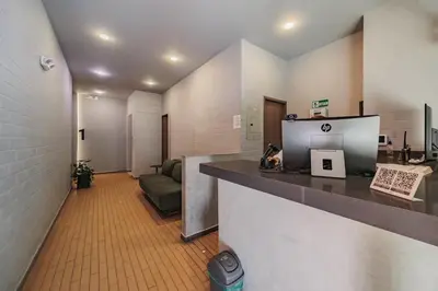 an office with a reception desk and a couch at Spot Building - Apartments in Medellín