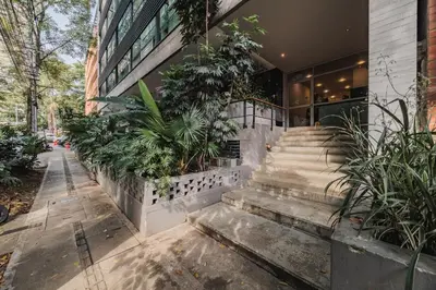 a building with stairs in front of it with plants at Spot Building - Apartments in Medellín