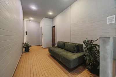 a living room with a couch and some plants at Spot Building - Apartments in Medellín
