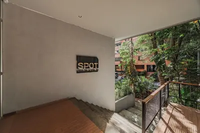 a sign for a spot on the wall of a building at Spot Building - Apartments in Medellín