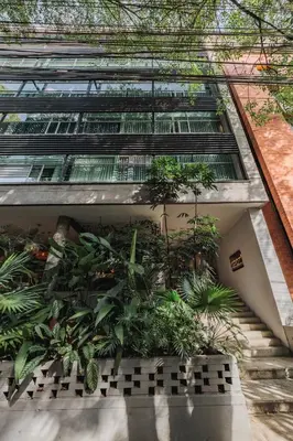 a building with a bunch of plants in it at Spot Building - Apartments in Medellín