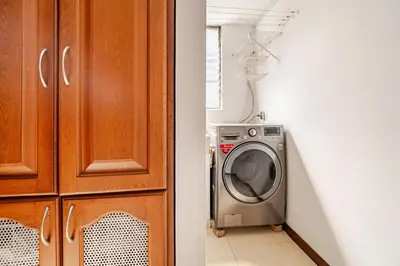 a washing machine in a kitchen next to a door at City views Air-conditioning Heated pool in Envigado