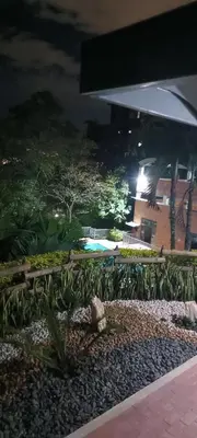 a view of a garden at night at City views Air-conditioning Heated pool in Envigado