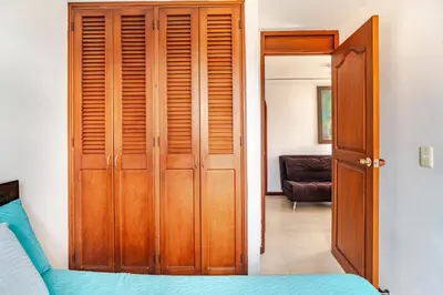 a bedroom with a wooden closet and a bed at City views Air-conditioning Heated pool in Envigado