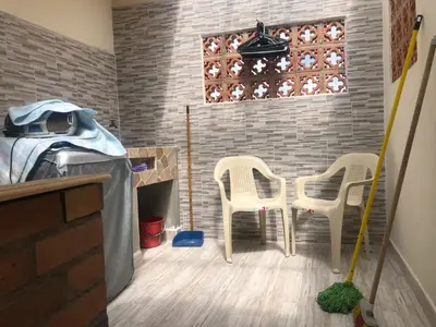 a room with two chairs and a table and a brick wall at habitación amoblada en sonson antioquia colombia in Sonsón