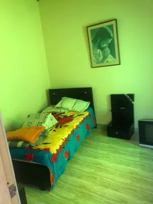 a bedroom with a bed with a colorful comforter at habitación amoblada en sonson antioquia colombia in Sonsón