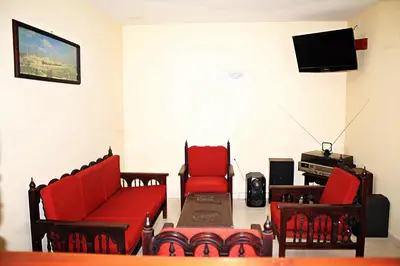 a living room with red furniture and a flat screen tv at Victoria Imperial Hotel in Mariquita