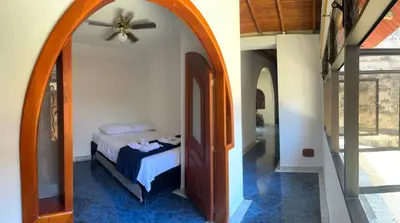 a bedroom with a bed and a ceiling fan at Casa grande parque central in San Rafael