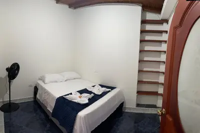 a bedroom with a bed with towels on it at Casa grande parque central in San Rafael