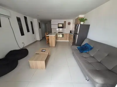 a living room with a couch and a kitchen at Apartamento Luareles-San joaquin-Balcon in Medellín