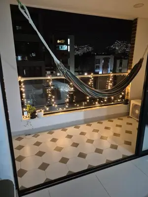 a balcony with a hammock and a view of a city at Apartamento Luareles-San joaquin-Balcon in Medellín