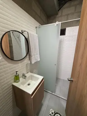 a bathroom with a sink and a mirror at Hospedaje San Diego in Medellín