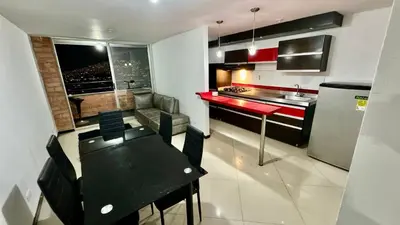 a kitchen with a black table and a red counter at Rodeo Alto in Belén