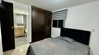 a bedroom with a large bed and a bathroom at Rodeo Alto in Belén