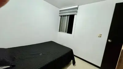 a bedroom with a black bed and a window at Rodeo Alto in Belén