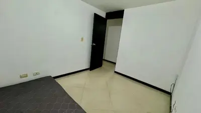 an empty room with a black door and white walls at Rodeo Alto in Belén