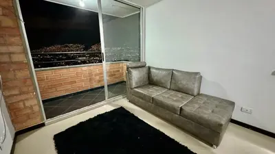 a couch sitting in a room with a window at Rodeo Alto in Belén