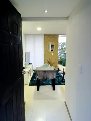 a hallway with a living room with a table at Apartment in Poblado - Medellín in Medellín