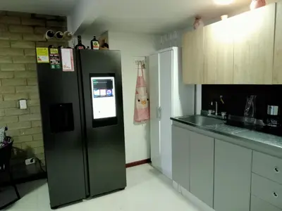 a kitchen with a black refrigerator and a counter at Apartment in Poblado - Medellín in Medellín
