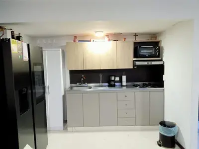 a small kitchen with a sink and a refrigerator at Apartment in Poblado - Medellín in Medellín