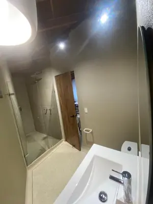 a bathroom with a white sink and a mirror at Hotel La Vega in Concepción