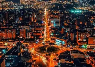 a city lit up at night with traffic at laureles excelente ubicacion la 70 estadio, cerca al poblado in Medellín