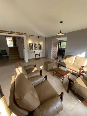 a large living room with couches and a table at Habitación con baño privado en casa de campo ubicada en Santa Elena in Santa Elena