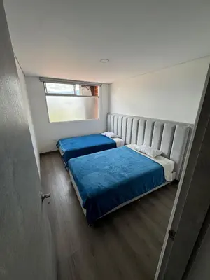 a bedroom with two beds and a window at Modern 3 Bedroom Apartment with balcony in Medellín