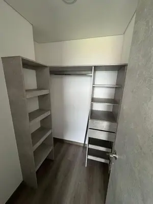 a room with a closet with shelves and a door at Modern 3 Bedroom Apartment with balcony in Medellín