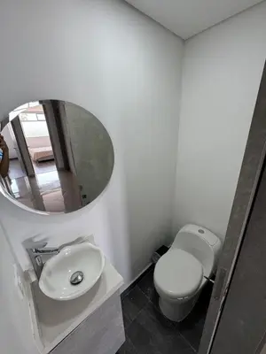 a bathroom with a white toilet and a mirror at Modern 3 Bedroom Apartment with balcony in Medellín