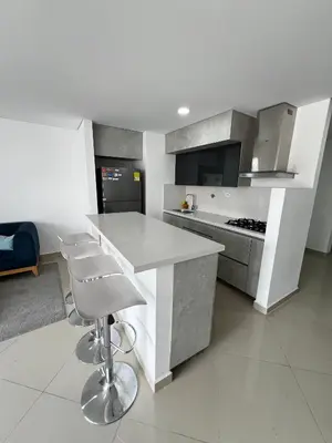a kitchen with a white counter and a kitchen island at Modern 3 Bedroom Apartment with balcony in Medellín