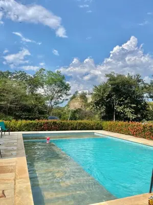 a swimming pool in a yard with a blue sky at Finca en sopetrán in Sopetran