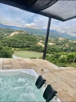a hot tub on a patio with a view of a mountain at Finca en sopetrán in Sopetran